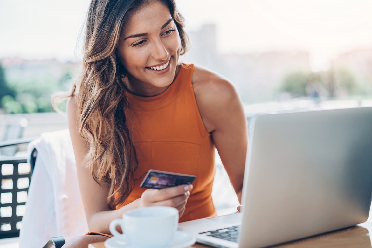Young woman with credit card and laptop